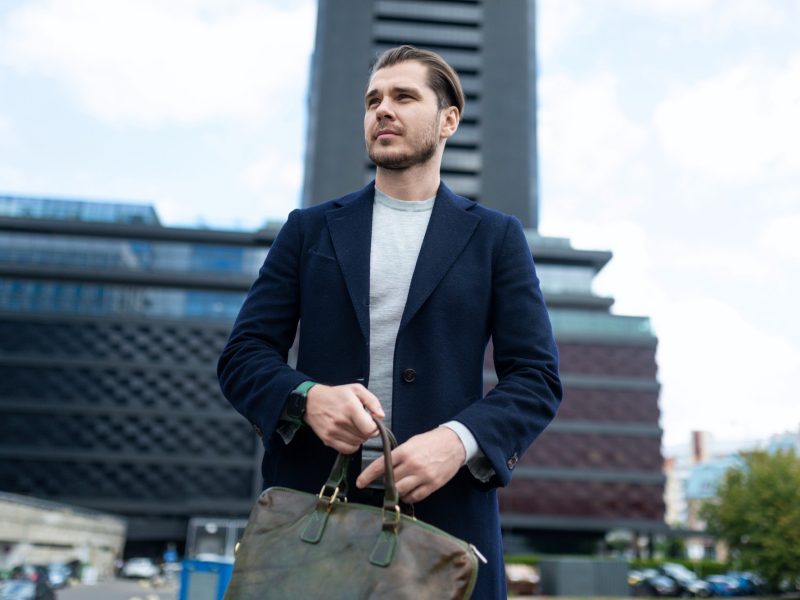 business man caucasian appearance with a bag for documents on the background of city administrative business man caucasian appearance with a bag for documents on the background of city administrative