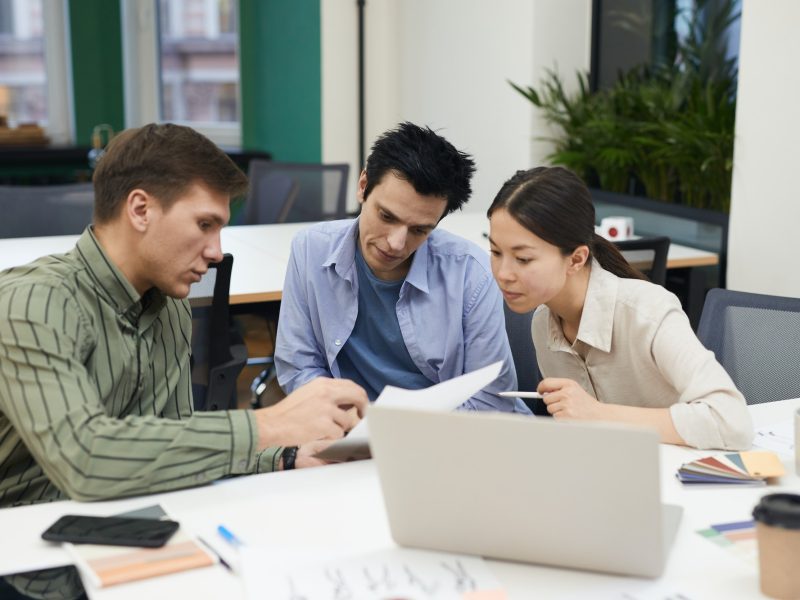 Business people examining the contract Business people examining the contract