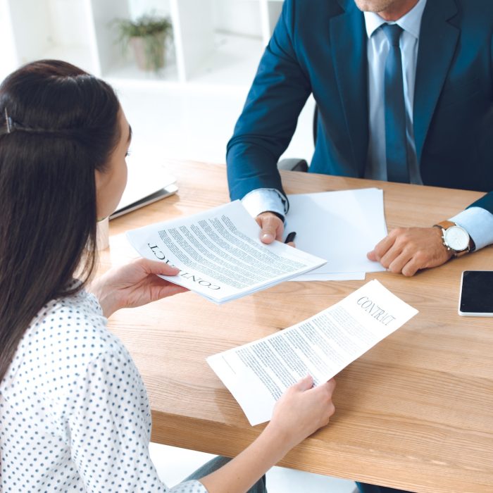 high angle view of lawyer and client discussing contract