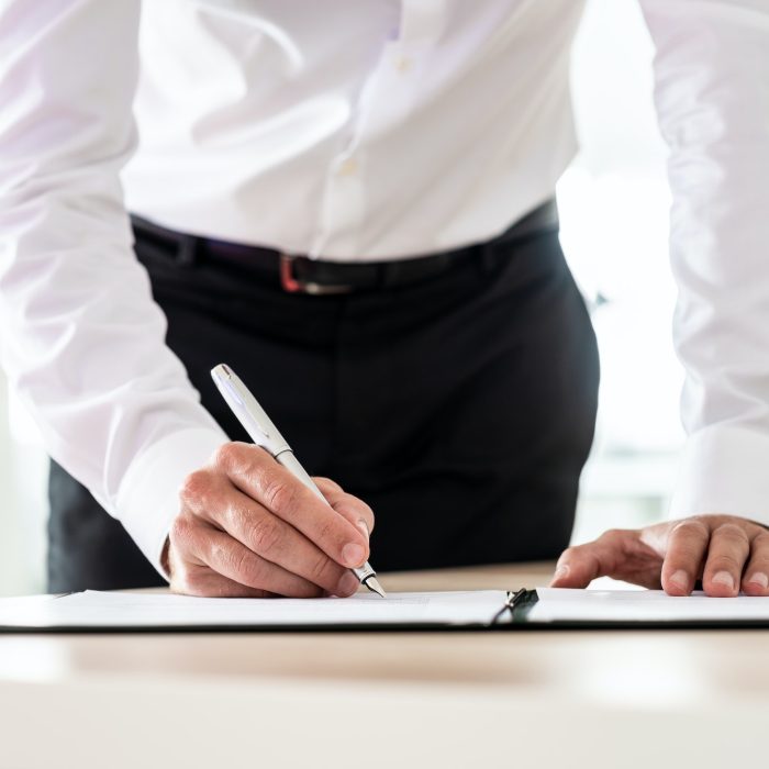 Lawyer signing an important document